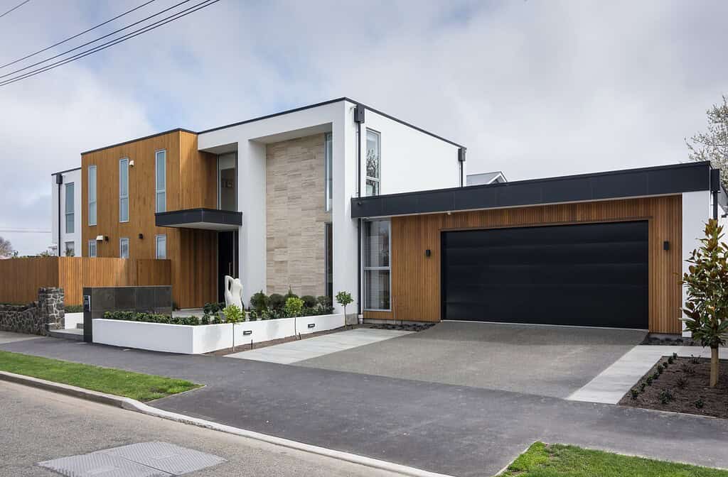 Street elevation of the five-bedroom architectural home in Christchurch, with cedar and white cladding and a double garage.