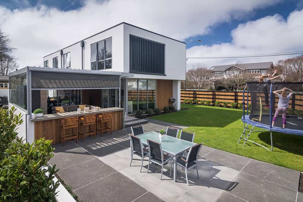Backyard of a Coughlan Homes build in Canterbury with an outdoor bar, patio and trampoline.