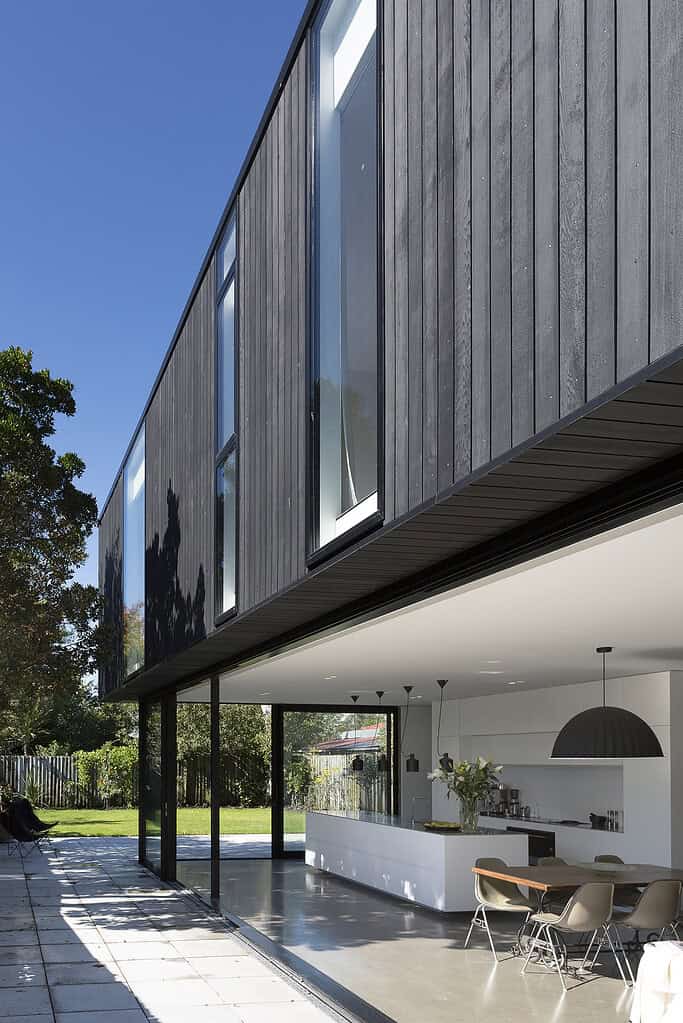 Contemporary Christchurch home with dark vertical cladding and open-plan living onto the garden.