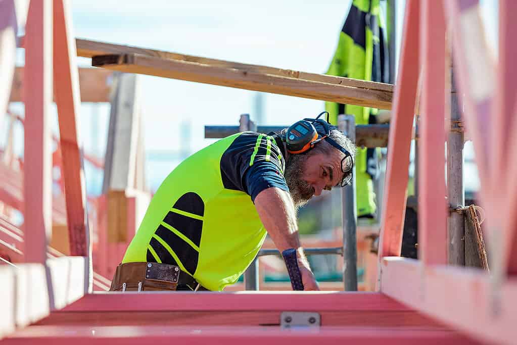 Coughlan Homes carpenter working on the timber frame of a home under construction in Canterbury.