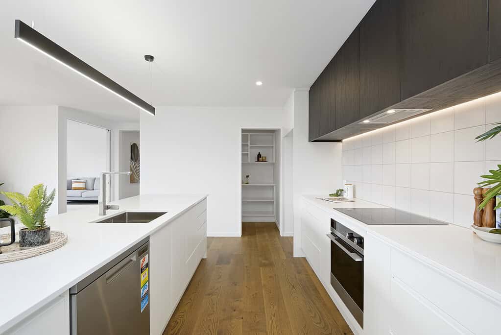Kitchen in a completed Coughlan Homes build with island bench and pendant lighting