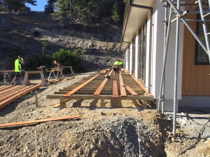 Coughlan Homes carpentry crew laying subfloor framing on a Canterbury build