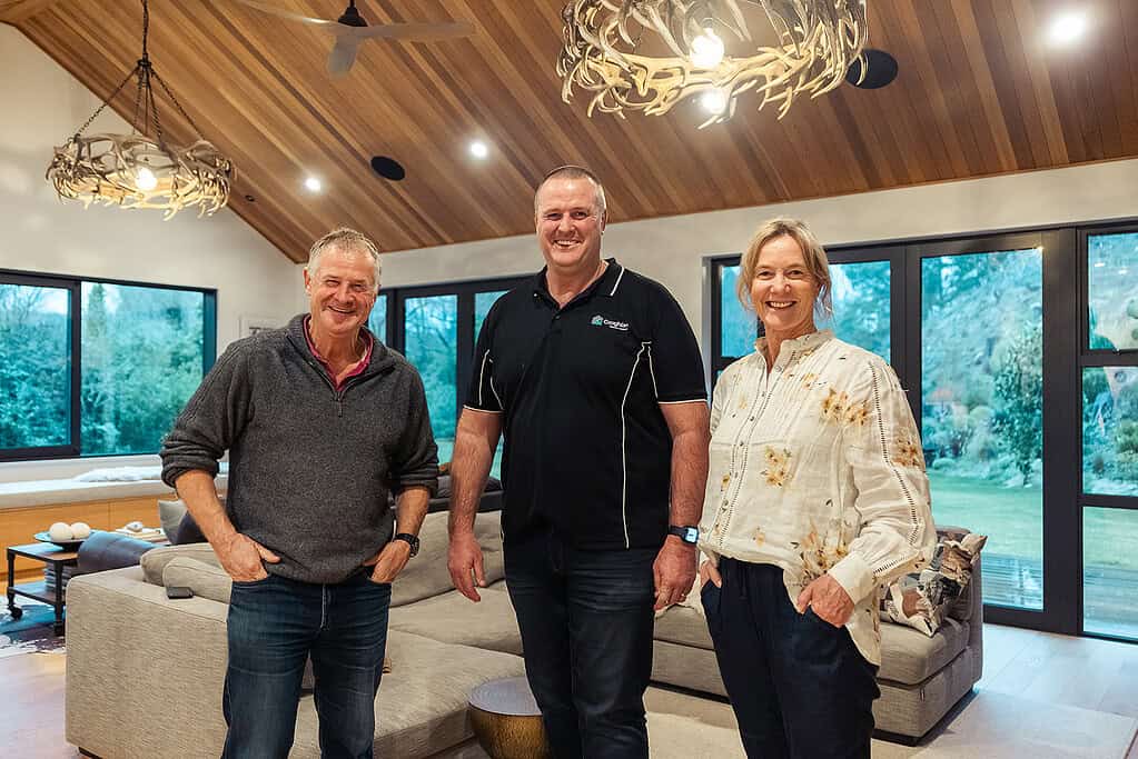 Homeowners with Coughlan Homes in the living area of their completed home