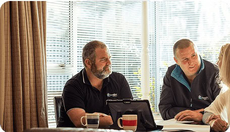 Pat Coughlan and Lawrence Buckley working through plans together at the Coughlan Homes office.