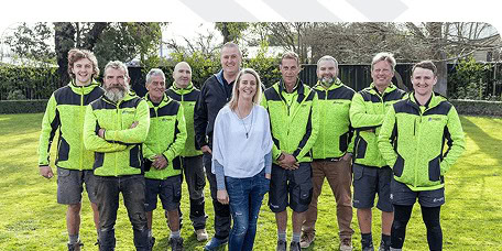 The Coughlan Homes team in branded hi-vis outside a completed Canterbury build.